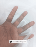 Hand wearing a sheer fabric glove on a white background with 'fabricdiary.com' branding.