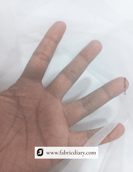 Hand wearing a sheer fabric glove on a white background with 'fabricdiary.com' branding.