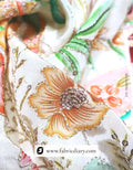 Lovely floral panel print fabric folded neatly on wood