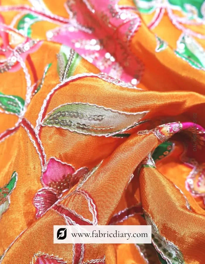 Tailor’s table with grey-orange floral fabric unfolded